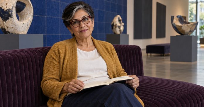 Woman reflecting with an open notebook on a purple gallery bench.