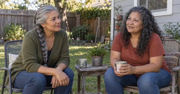 Two adults having a respectful conversation on simple patio chairs in a modest backyard.