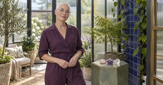 Crystals as personal symbolic objects Woman with a white buzz cut beside three polished stones on a green pedestal